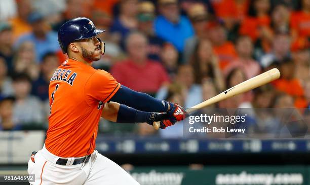 Carlos Correa of the Houston Astros doubles in the second inning against the Kansas City Royals at Minute Maid Park on June 22, 2018 in Houston,...