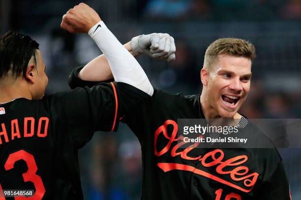 Chris Davis of the Baltimore Orioles celebrates a solo home run with Manny Machado during the fifth inning against the Atlanta Braves at SunTrust...