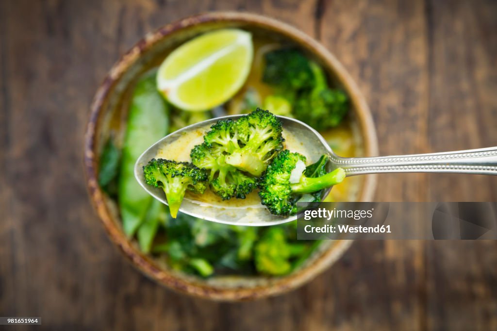 Spoon of green thai curry , close-up