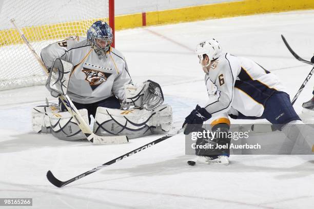 Goaltender Dan Ellis defends the net as Shea Weber of the Nashville Predators and the puck slide towards the net against the Florida Panthers on...