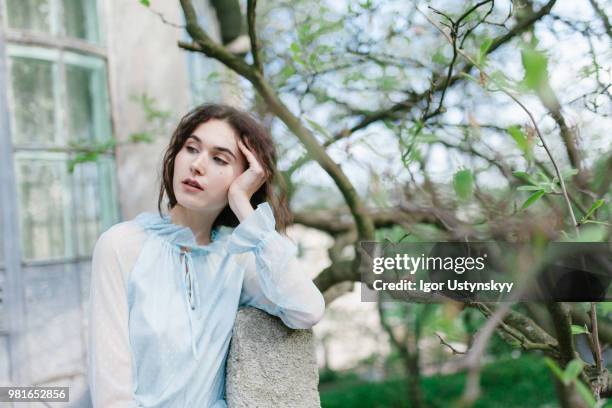 young woman resting in public park - リヴィウ ストックフォトと画像