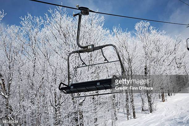 a resort chair lift. - mont tremblant ski village stock pictures, royalty-free photos & images