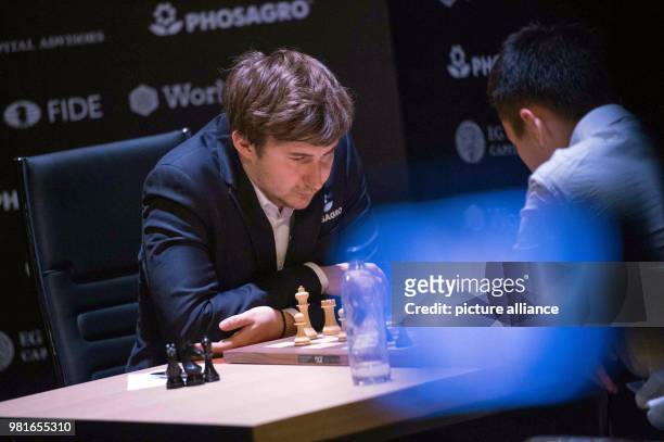 March 2018, Germany, Berlin: Sergei Alexandrowitsch Karjakin , chess grand master of Russia, and Ding Liren, chess grand master of China, playing at...