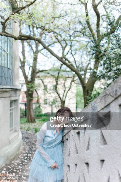 young woman resting in public park - リヴィウ ストックフォトと画像