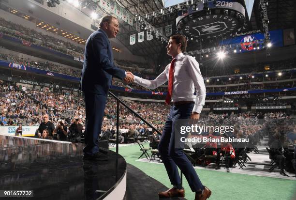 Oliver Wahlstrom shakes the hand of NHL Commissioner Gary Bettman after being selected eleventh overall by the New York Islanders during the first...