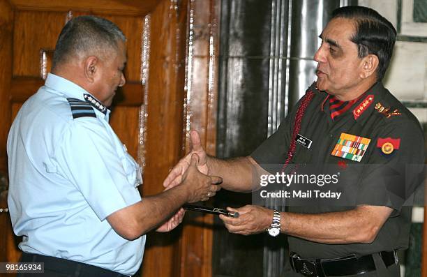 Outgoing Chairman of Chiefs of Staff Committee General Deepak Kapoor handing over the COSC baton to his successor Air Chief Marshal PV Naik during a...