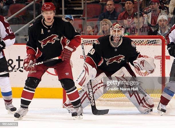 Goaltender Ilya Bryzgalov and teammate Zbynek Michalek of the Phoenix Coyotes look for the puck up ice against the Colorado Avalanche on March 27,...