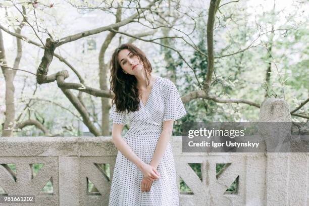 young woman resting in public park - リヴィウ ストックフォトと画像