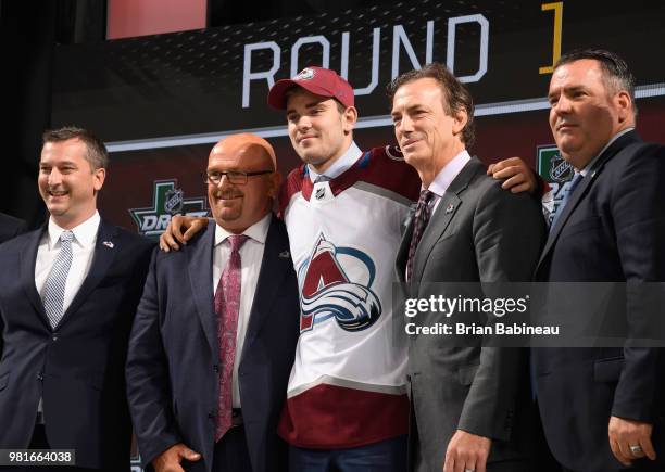 Martin Kaut poses with team personel onstage after being selected sixteenth overall by the Colorado Avalanche during the first round of the 2018 NHL...