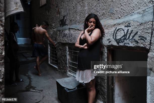 Woman waits for help to repair a wall in her house at the Rocinha favela in Rio de Janeiro, Brazil, 27 March 2018. Photo: Diego Herculano/dpa