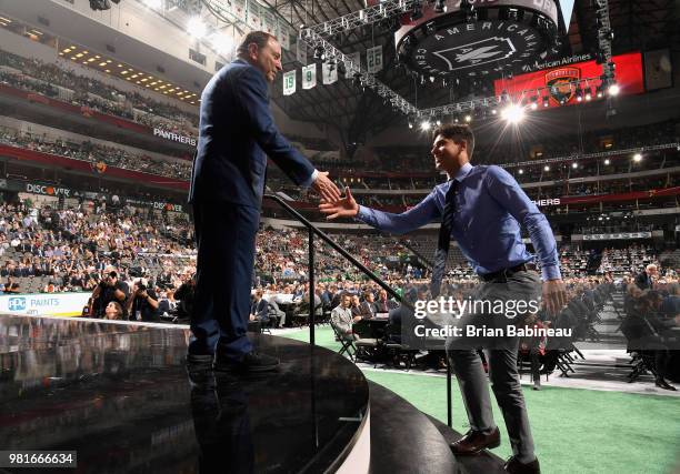 Grigori Denisenko greets NHL commissioner Gary Bettman after being selected fifteenth overall by the Florida Panthers during the first round of the...
