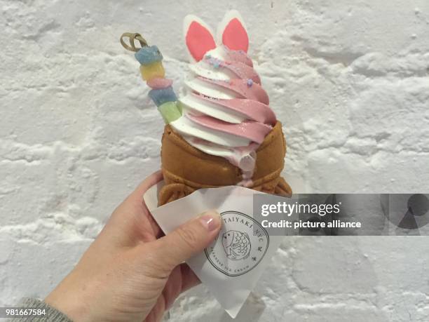 March 2018, USA, New York: White rabbit ears decorate an ice cone of ice cream place Taiyaki in Manhattan. The so called 'Easter Kones' are made out...