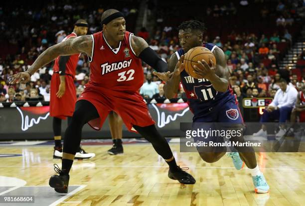 Nate Robinson of Tri State drives against Rashad McCants of Trilogy during week one of the BIG3 three on three basketball league at Toyota Center on...