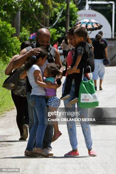 An Honduran immigrant is received by his family at the Ramon Villeda Morales airport, in San Pedro Sula, 200 kilometres north of Tegucigalpa, after...