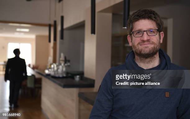 March 2018, Germany, Kirchboitzen: Torsten Soeder, member of the board of the cooperative society Kirchboitzer Zukunft stands at the renovated bar of...