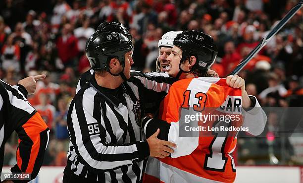 Linesmen Jonny Murray separates Dan Carcillo of the Philadelphia Flyers from David Clarkson of the New Jersey Devils on March 28, 2010 at the...