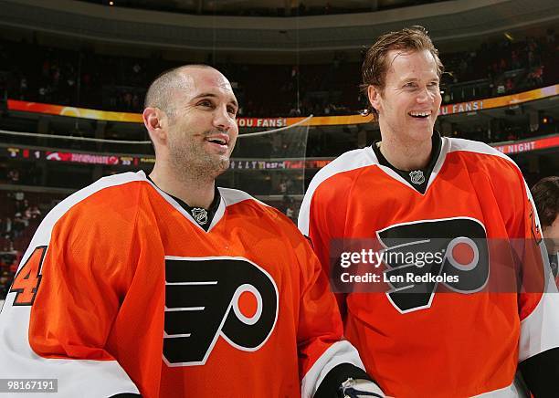 Ian Laperriere and Chris Pronger of the Philadelphia Flyers smile during the conclusion of Fan Appreciation night after defeating the New Jersey...