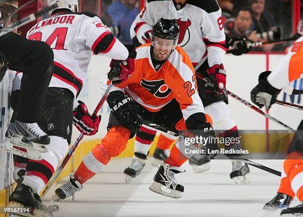 Ville Leino of the Philadelphia Flyers battles for the puck along the boards against Bryce Salvador of the New Jersey Devils on March 28, 2010 at the...