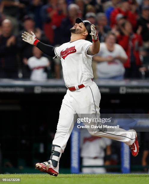 Yonder Alonso of the Cleveland Indians celebrates as he rounds the bases after hitting a grand slam home run off of Johnny Barbato of the Detroit...