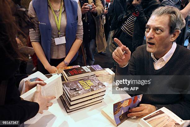 Writer Paul Auster signs books during the Paris' book fair, on March 27, 2010. The 30th edition of the fair runs from March 26 to March 31, 2010 in...