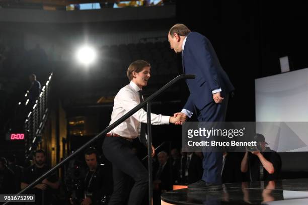 Isac Lundestrom shakes hands wtih NHL commissioner Gary Bettman after being selected twenty-third overall by the Anaheim Ducks during the first round...