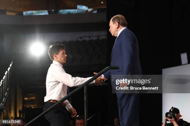 Jay O'Brien shakes hands wtih NHL commissioner Gary Bettman after being selected nineteenth overall by the Philadelphia Flyers during the first round...