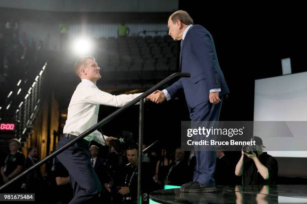 Ty Dellandrea shakes hands wtih NHL commissioner Gary Bettman after being selected thirteenth overall by the Dallas Stars during the first round of...