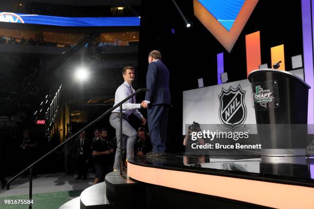 Oliver Wahlstrom shakes hands wtih NHL commissioner Gary Bettman after being selected eleventh overall by the New York Islanders during the first...