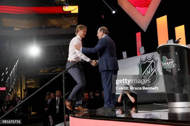 Adam Boqvist shakes hands wtih NHL commissioner Gary Bettman after being selected eighth overall by the Chicago Blackhawks during the first round of...