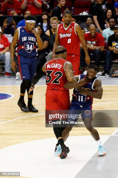 Rashad McCants of Trilogy holds Nate Robinson of Tri State during week one of the BIG3 three on three basketball league at Toyota Center on June 22,...