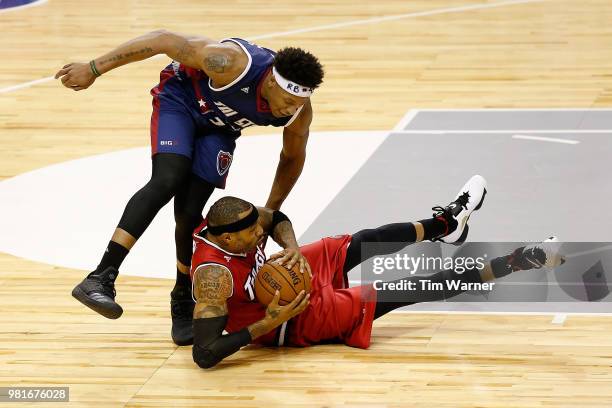 Rashad McCants of Trilogy and David Hawkins of Tri State contend for the ball during week one of the BIG3 three on three basketball league at Toyota...