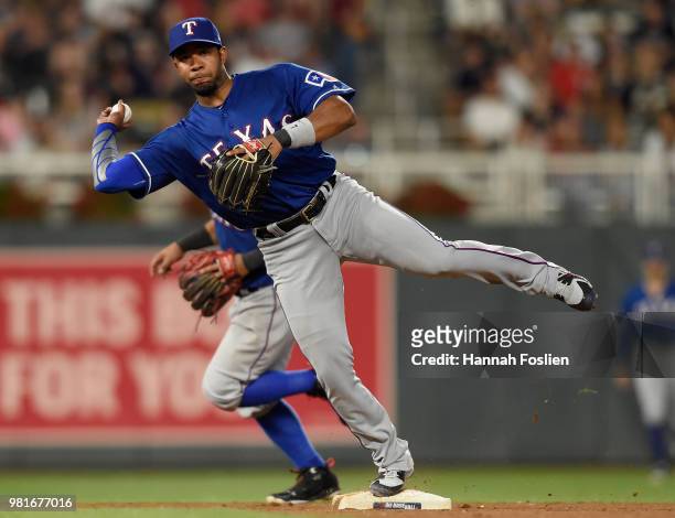 Elvis Andrus of the Texas Rangers makes a play at shortstop to get out Taylor Motter of the Minnesota Twins at first base during the seventh inning...