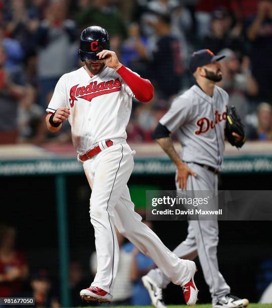 Tyler Naquin of the Cleveland Indians scores on a double by Michael Brantley as pitcher Mike Fiers of the Detroit Tigers backs up the play during the...