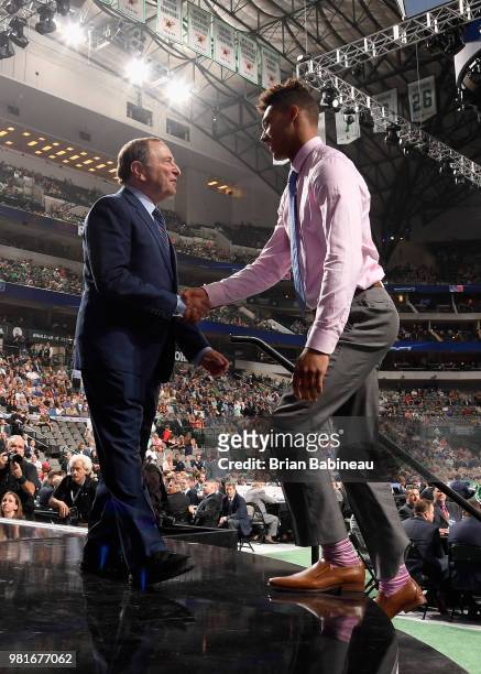 Andre Miller greets NHL commissioner Gary Bettman after being selected twenty-second overall by the New York Rangers during the first round of the...