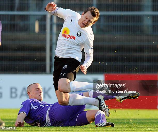 Tobias Nickenig of Osnabrueck tackles Regis Dorn of Sandhausen during the 3. Liga match between SV Sandhausen and VfL Osnabrueck at the Hardtwald...