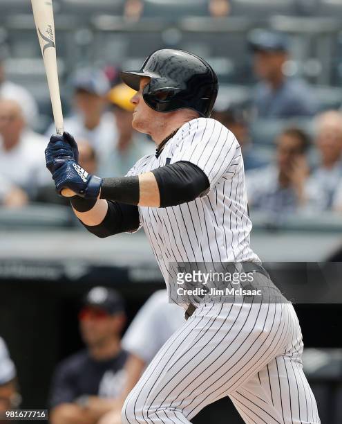 Clint Frazier of the New York Yankees follows through on a first inning single against the Seattle Mariners at Yankee Stadium on June 21, 2018 in the...
