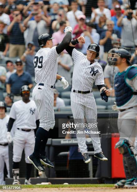 Aaron Judge of the New York Yankees celebrates his first inning two run home run against the Seattle Mariners with teammate Clint Frazier at Yankee...