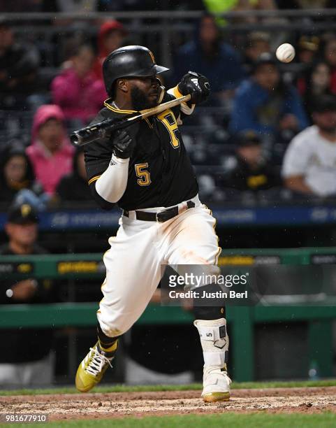 Josh Harrison of the Pittsburgh Pirates attempts a bunt in the eleventh inning during the game against the Arizona Diamondbacks at PNC Park on June...