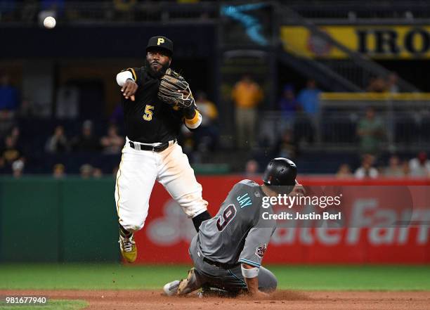 Josh Harrison of the Pittsburgh Pirates attempts to turn a double play on Jon Jay of the Arizona Diamondbacks in the eleventh inning during the game...