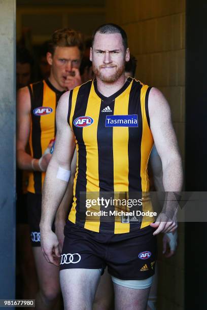 Jarryd Roughead of the Hawks leads the team out during the round 14 AFL match between the Hawthorn Hawks and the Gold Coast Suns at University of...