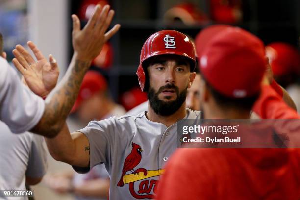 Matt Carpenter of the St. Louis Cardinals celebrates with teammates after scoring a run in the third inning against the Milwaukee Brewers at Miller...