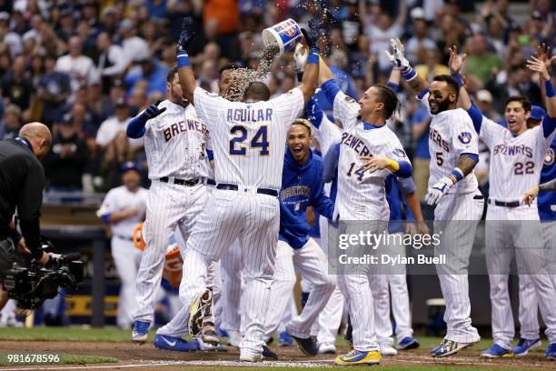 Jesus Aguilar of the Milwaukee Brewers celebrates with teammates after hitting a walk-off home run to beat the St. Louis Cardinals 2-1 at Miller Park...