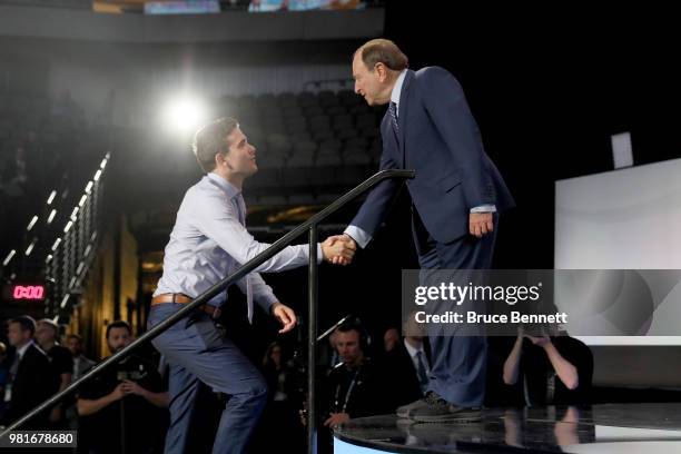 Martin Kaut shakes hands with NHL commissioner Gary Bettman after being selected sixteenth overall by the Colorado Avalancheduring the first round of...