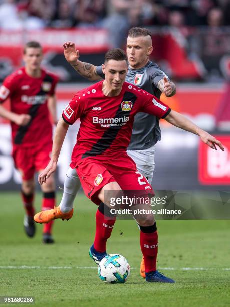 March 2018, Germany, Leverkusen: soccer, Bundesliga, Bayer Leverkusen vs FC Augsburg in the BayArena. Leverkusen's Dominik Kohr and Augsburg's...