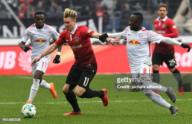 March 2018, Germany, Hannover: soccer, Bundesliga, Hannover 96 vs RB Leipzig in the HDI Arena. Hannover's Felix Klaus and Leipzig's Bruma and Naby...