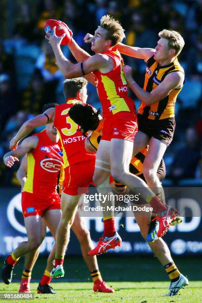 Tom Lynch of the Suns marks the ball against James Sicily of the Hawks during the round 14 AFL match between the Hawthorn Hawks and the Gold Coast...