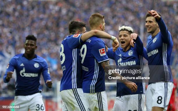 March 2018, Germany, Gelsenkirchen: soccer, Bundesliga, FC Schalke 04 vs SC Freiburg in the Veltins Arena: Schalke's Breel Embolo , Daniel Caligiuri,...