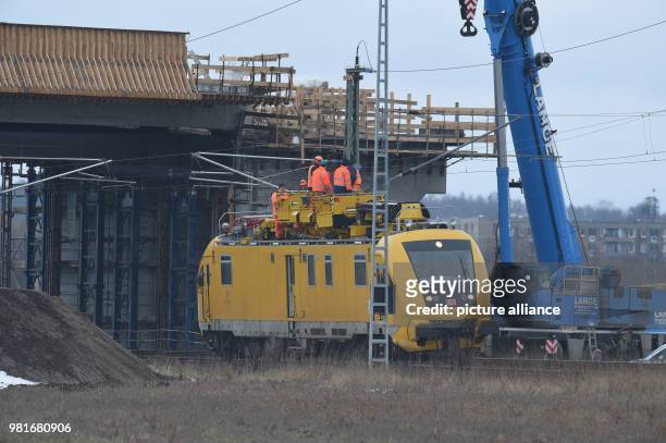 March 2018, Germany, Bergen: Employees of the railway work on the overhead lines at the track between Bergen and Samtens on the island of Ruegen. The...