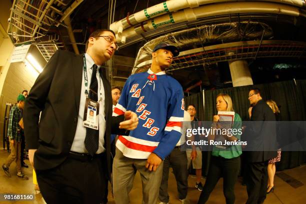 Andre Miller walks through the hallways after being selected twenty-second overall by the New York Rangers during the first round of the 2018 NHL...