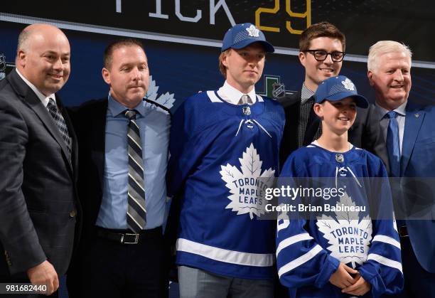 Rasmus Sandin poses for a photo onstage after being selected twenty-ninth overall by the Toronto Maple Leafs during the first round of the 2018 NHL...